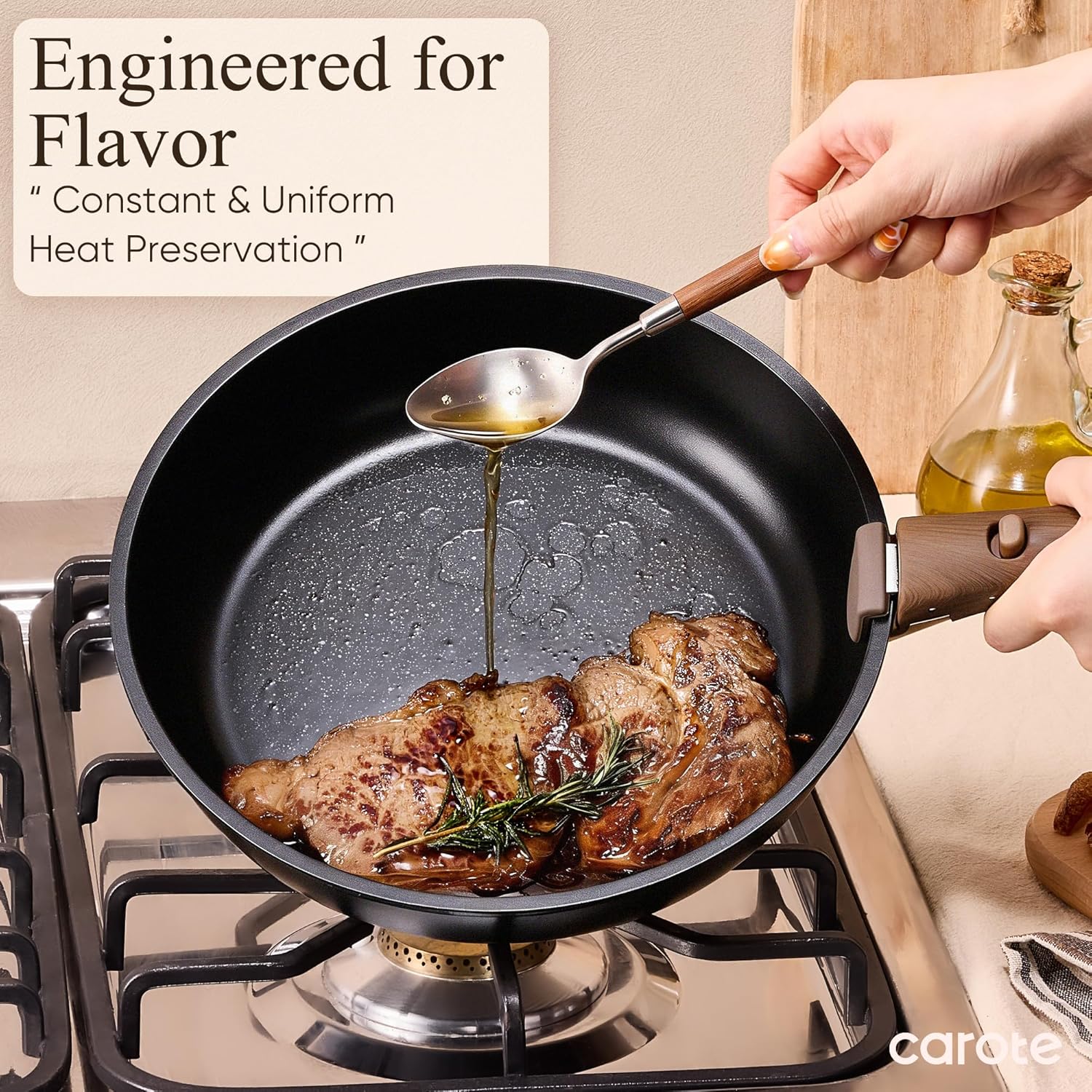 Meat cooking in the frying pan on a gas hob while oil is spooned over it